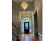 Elegant foyer with a stunning chandelier, arched doorway, and hardwood floors at 370 Buchanan Circle Tract 1, Dallas, GA 30157
