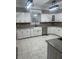 Bright kitchen features white cabinets, farmhouse sink, granite countertops, and modern lighting at 370 Buchanan Circle Tract 1, Dallas, GA 30157