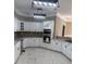 Bright kitchen with white cabinets, granite counters, tile floors, and modern lighting fixtures at 370 Buchanan Circle Tract 1, Dallas, GA 30157