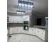 A well-lit kitchen features white cabinetry, granite countertops, modern appliances, and tile flooring at 370 Buchanan Circle Tract 1, Dallas, GA 30157