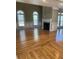 Living room featuring wood flooring, a fireplace, wainscotting, and multiple windows providing natural light at 370 Buchanan Circle Tract 1, Dallas, GA 30157