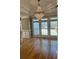Living room featuring wood flooring, tray ceiling, wainscotting, and multiple windows providing natural light at 370 Buchanan Circle Tract 1, Dallas, GA 30157