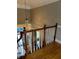 Staircase landing with wood flooring, white railings, and a decorative chandelier at 370 Buchanan Circle Tract 1, Dallas, GA 30157