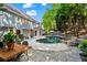 Charming backyard with pool, brick patio, outdoor dining set, and grill at 4794 Dalhousie Ne Pl, Marietta, GA 30068