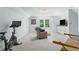 Spacious bonus room with a peloton, comfortable seating, and built-in cabinets at 4794 Dalhousie Ne Pl, Marietta, GA 30068