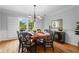 Dining room with hardwood floors, seating for six, wainscotting, and a window with plantation shutters at 4794 Dalhousie Ne Pl, Marietta, GA 30068