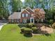 Charming two-story brick home with mature landscaping, lush green lawn, and inviting curb appeal at 4794 Dalhousie Ne Pl, Marietta, GA 30068