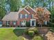 Beautiful brick home featuring a well-manicured lawn, symmetrical facade, and dark blue shutters at 4794 Dalhousie Ne Pl, Marietta, GA 30068