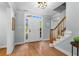 Bright foyer with hardwood floors, staircase with wooden railing, and a front door with sidelights at 4794 Dalhousie Ne Pl, Marietta, GA 30068