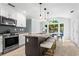 Modern kitchen with granite countertops, stainless steel appliances, and an island with barstool seating at 4794 Dalhousie Ne Pl, Marietta, GA 30068