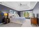 Spacious bedroom with tray ceilings, ceiling fan, neutral carpet and a window with shutters at 4794 Dalhousie Ne Pl, Marietta, GA 30068