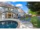 A lovely outdoor pool and patio with lounge chairs and lush landscaping at 4794 Dalhousie Ne Pl, Marietta, GA 30068