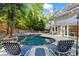 Beautiful backyard pool and patio with outdoor seating, lounge chairs, and lush landscaping at 4794 Dalhousie Ne Pl, Marietta, GA 30068