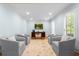 Formal sitting room with hardwood floors, shuttered windows, and furniture arranged for conversation at 4794 Dalhousie Ne Pl, Marietta, GA 30068