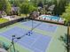 Aerial view of community tennis courts with a pool and seating area at 4794 Dalhousie Ne Pl, Marietta, GA 30068
