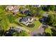 Beautiful home from above featuring lush landscaping, a swimming pool and mature trees along the property line at 7390 Canter Run, Cumming, GA 30040