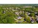 Wide aerial view showcasing the neighborhood with plentiful trees surrounding well-maintained homes and landscaping at 7390 Canter Run, Cumming, GA 30040
