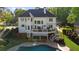 Expansive backyard featuring a private pool, spacious deck, and manicured landscaping for outdoor enjoyment at 7390 Canter Run, Cumming, GA 30040