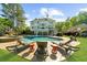 A spacious backyard featuring a swimming pool, lounge chairs, and lush green landscaping for relaxation at 7390 Canter Run, Cumming, GA 30040