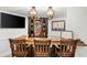 A basement bar area with wood counter, display shelves, ambient lighting, and dark wood accents at 7390 Canter Run, Cumming, GA 30040