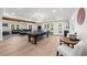 Spacious recreational room with a pool table, living area, and ample space for entertaining guests at 7390 Canter Run, Cumming, GA 30040