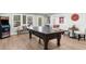 Brightly lit game room features a ping pong table and an arcade game perfect for entertaining Gathering and friends at 7390 Canter Run, Cumming, GA 30040