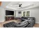 Inviting basement featuring a sectional sofa, large screen TV, and a relaxing entertainment space for Gathering and friends at 7390 Canter Run, Cumming, GA 30040