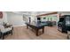 Spacious basement with ping pong table, recessed lighting, and comfortable seating area perfect for entertaining at 7390 Canter Run, Cumming, GA 30040