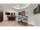 Basement with a wet bar area with wood counter, gaming memorabilia, and a lounge area for relaxation at 7390 Canter Run, Cumming, GA 30040