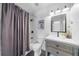 Bathroom featuring a shower, vanity with a sink, and gray hexagon tile flooring at 7390 Canter Run, Cumming, GA 30040