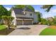 View of a three car garage exterior, concrete drive, with a basketball hoop and landscaped yard at 7390 Canter Run, Cumming, GA 30040