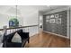 Hallway featuring wood floors, modern railing, and a black bench at 7390 Canter Run, Cumming, GA 30040