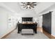 Large main bedroom with tray ceiling, gray rug, and view of sliding barn door entrance at 7390 Canter Run, Cumming, GA 30040