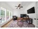 Bright home office with wooden floors, shutters, and a ceiling fan at 7390 Canter Run, Cumming, GA 30040