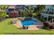Refreshing pool area with spa, lounge chairs, and meticulously kept landscaping in a private backyard setting at 7390 Canter Run, Cumming, GA 30040