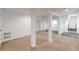 Unfinished basement with neutral carpet, support beams and tile flooring in adjacent room at 1195 Cameron Ne Ct, Atlanta, GA 30306