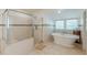 Bright bathroom featuring a glass-enclosed shower and soaking tub near windows at 1195 Cameron Ne Ct, Atlanta, GA 30306