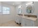 Bathroom with dual vanities, tiled floors, and bright lighting at 1195 Cameron Ne Ct, Atlanta, GA 30306