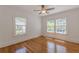 Bedroom featuring hardwood floors, neutral paint, and two sunny windows at 1195 Cameron Ne Ct, Atlanta, GA 30306
