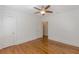 Bedroom with hardwood floors, white trim, neutral paint, and several doorways at 1195 Cameron Ne Ct, Atlanta, GA 30306