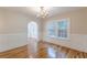 Dining room with beautiful hardwood floors, wainscoting, and arched doorway at 1195 Cameron Ne Ct, Atlanta, GA 30306