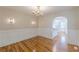 Elegant dining room with wainscoting, stylish chandelier, and hardwood floors at 1195 Cameron Ne Ct, Atlanta, GA 30306