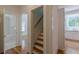 Bright hallway featuring hardwood floors, access to the bathroom, and stairs to the upper level at 1195 Cameron Ne Ct, Atlanta, GA 30306