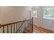 Upstairs hallway with hardwood flooring and natural light from nearby windows at 1195 Cameron Ne Ct, Atlanta, GA 30306