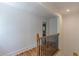 Upstairs hallway with hardwood floors and a decorative wrought iron railing at 1195 Cameron Ne Ct, Atlanta, GA 30306