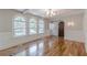 Inviting living room with arched windows, hardwood floors and a charming chandelier at 1195 Cameron Ne Ct, Atlanta, GA 30306
