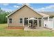 A backyard view showcasing a charming screened-in porch and a brick patio perfect for outdoor entertaining at 155 Point View Dr, Canton, GA 30114