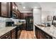 Beautiful kitchen featuring dark wood cabinets, granite countertops, stainless steel appliances, and great lighting at 155 Point View Dr, Canton, GA 30114