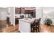 Well-appointed kitchen with a center island, dark wood cabinets, granite countertops, and modern appliances at 155 Point View Dr, Canton, GA 30114