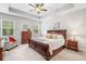Tranquil main bedroom with a tray ceiling, large windows, and a cozy sitting area for relaxation at 155 Point View Dr, Canton, GA 30114